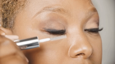 woman demonstrating how to apply a lash sealant