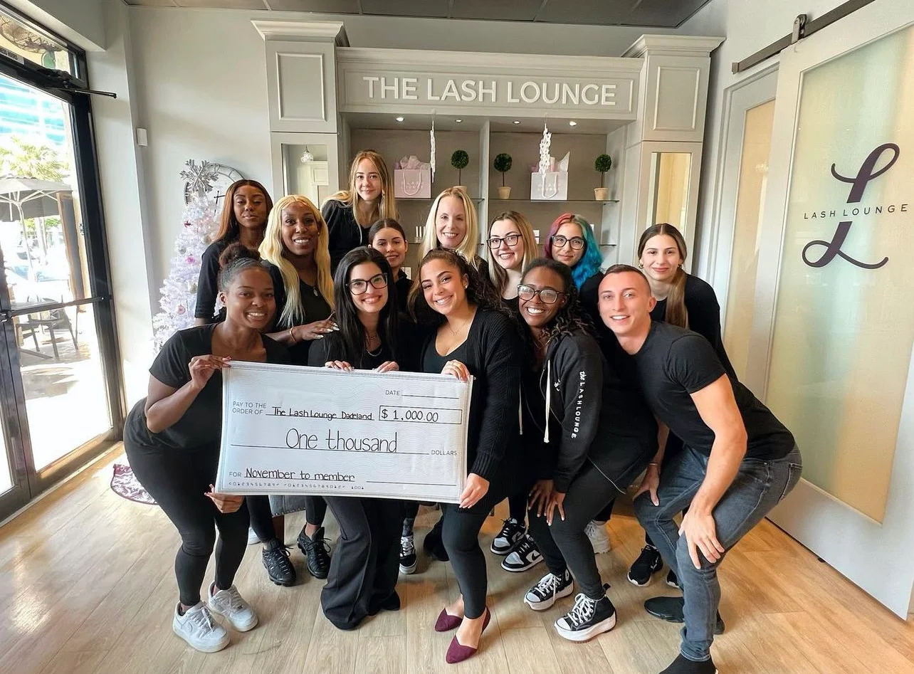 salon team with large award check